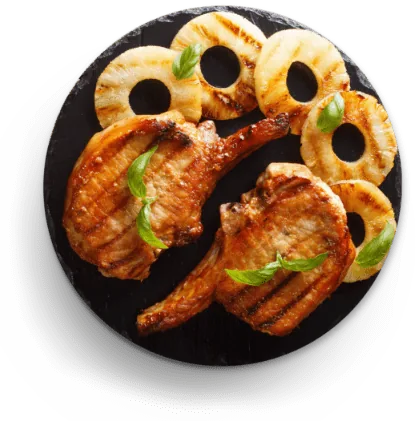 Grilled pork chops with pineapple on a plate